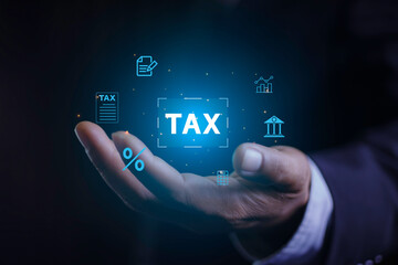 income tax concept. Businessman pointing to tax icon. income tax system icon around. pay online income tax. futuristic virtual screen interface technology..