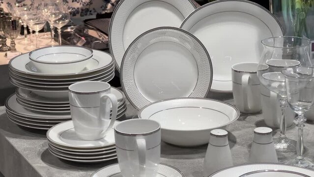 New stacked plates, cups and glasses in the crockery store or tableware shop