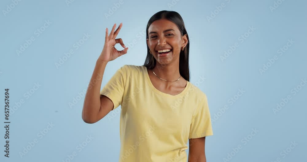 Sticker Okay sign, face and woman in studio for vote, certified review or feedback on blue background. Portrait, happy indian model and ok for success, agreement and icon of support, yes emoji and excellence