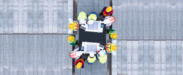 Top view of architectural engineering discussion at the table and his blueprints on Precast...