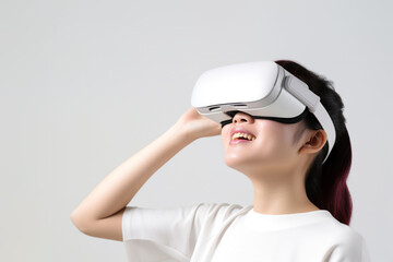 Young woman wearing virtual reality VR glasses, VR headset and trying to touch something with her hand while standing on white background.