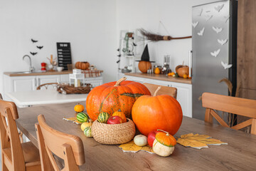 Obraz na płótnie Canvas Halloween pumpkins on dining table in kitchen