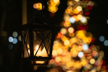 Fototapeta na wymiar dark warm gold Christmas decoration tree ornament and lantern candle at night