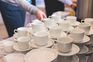 Set of coffee break lunch in the hotel restaurant during conference meeting, with tea and coffee catering, decorated banquet table with white tableware and metal tea maker machine boiler