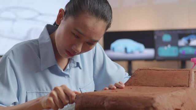 Woman Designer With Green Screen Laptop While Working On Car Clay

