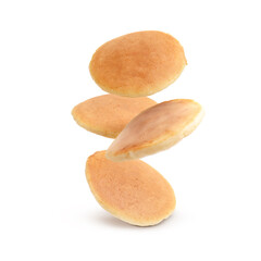 Tasty fresh pancakes falling on white background