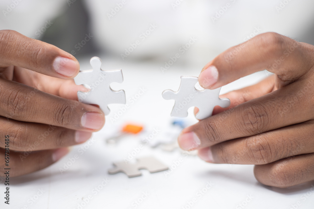 Wall mural business strategy ideas Business team planning a strategic meeting Assembling jigsaw pieces, using jigsaw puzzles, showing solutions for business people, teamwork.	