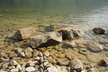 Rocks at the shore of Alouette Lake  at the Golden Ears Provincial Park in Maple Ridge, British Columbia, Canada.