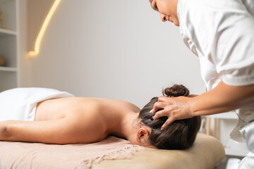 Woman receiving a relaxed head massage in a beauty salon
