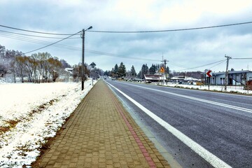 Snowy winter road in the countryside of Podkarpackie Voivodeship, Poland.