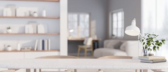A copy space on a tabletop over a blurred minimal white living room in the background.