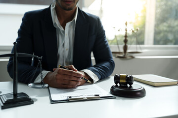 Young lawyer or legal advisor is reading and carefully checking the validity of documents and investment agreements for signing contracts managing justice concepts.