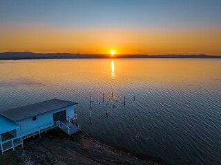 Sunset over the lake and boathouse