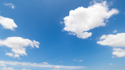 Panoramic view of clear blue sky and clouds, Blue sky background with tiny clouds. White fluffy clouds in the blue sky. Captivating stock photo featuring the mesmerizing beauty of the sky and clouds.