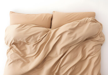The head of a bed set done in tan sheets and pillow cases, isolated on white; messy comforter - obrazy, fototapety, plakaty