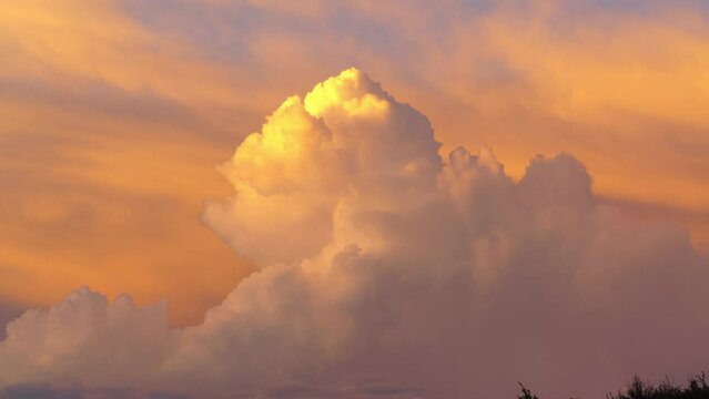 Timelapse of cumulonimbus clouds illuminated in sunset over Sierra Nevada mountains in California, USA