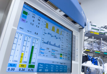 Medical monitor displays vital signs with graphs and numbers, heart rate, blood pressure,...