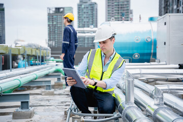 Industrial Professionals Ensuring Efficiency in HVAC Systems. Engineers is checking the air...