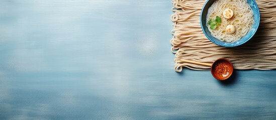 Ramen noodles on a bamboo mat with chopsticks isolated pastel background Copy space
