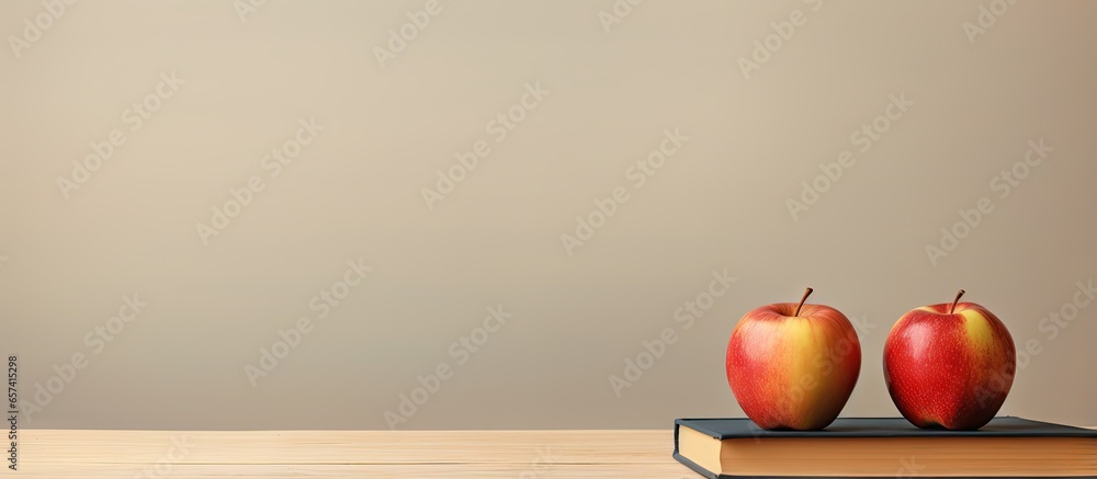 Poster copy space image on isolated background with an apple on top of books