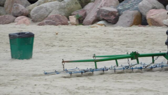 Tractor Dragging Harrow On The Sand. - close up