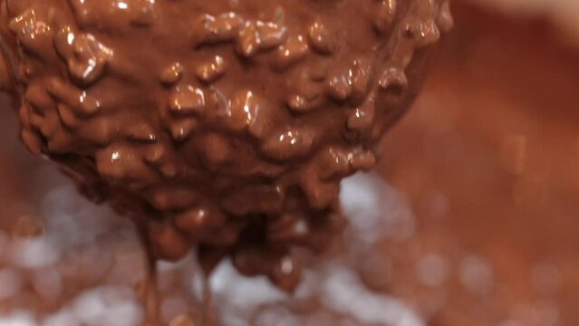 Cholotae ferrero donut being decorated dipped in cholocate