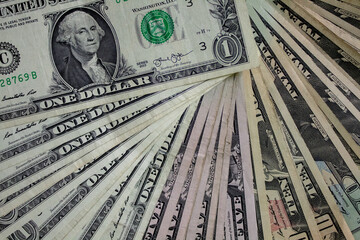 Money background of different denomination USD bills fanned out. - obrazy, fototapety, plakaty