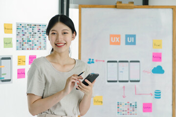 Portrait of creative UX UI designer working on screens for mobile responsive website development,...