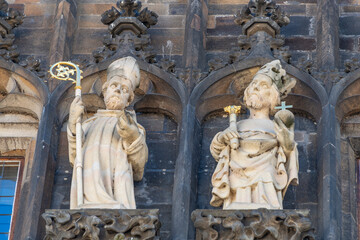 Scalptures of saints and priests at the old town Charles Bridge Tower Gateway in Prague, Czech...