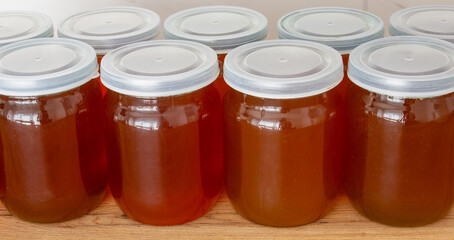 Close-up of fresh buckwheat honey in jars on the table.