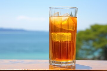 condensation on an iced tea glass with a beach background