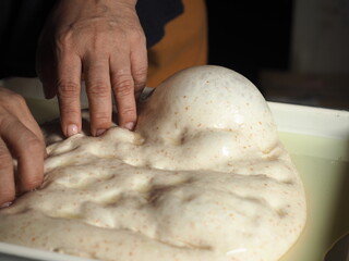 finger pressing focaccia bread dough