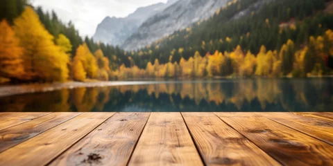 Selbstklebende Fototapete Berge The empty wooden table top with blur background of lake and mountain in autumn. Exuberant image.