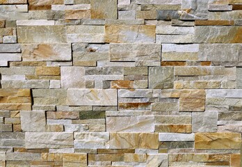 Stone wall made of  natural multicolor rocks of different sizes and shapes. Panels for exterior,...