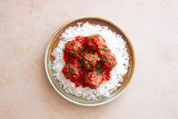 Rice with meatballs in tomato sauce. Italian food.