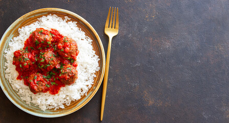 Rice with meatballs in tomato sauce. Italian food.