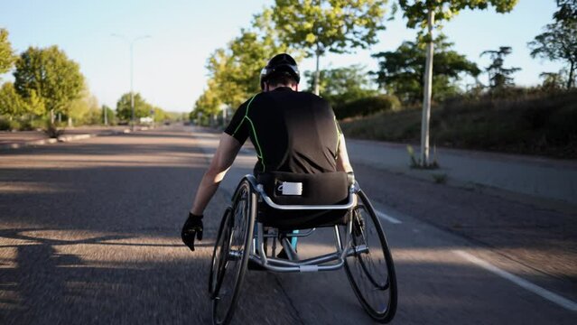 disabled man training on the street with racing wheelchair