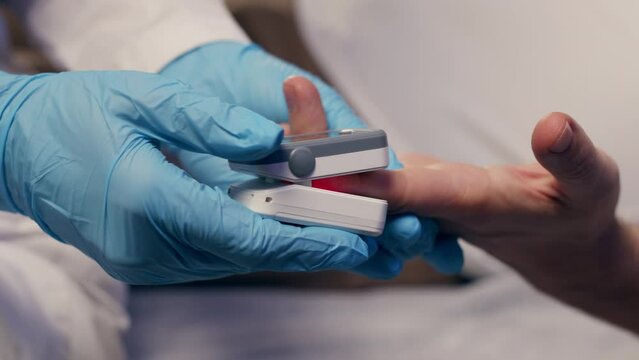Pulse oximeter on a white background. Infrared isometric thermometer to check body temperature for virus symptoms. Measures oxygen saturation, heart rate and oxygen levels.