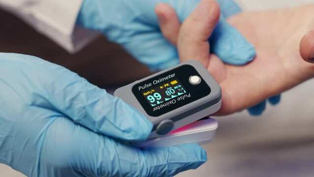 Pulse oximeter on a white background. Infrared isometric thermometer to check body temperature for virus symptoms. Measures oxygen saturation, heart rate and oxygen levels.
