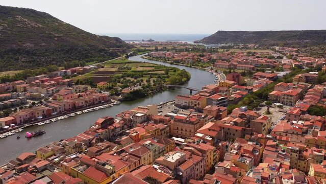 Colourful Bosa rooftops houses with view of River Temo in Sardinia, aerial