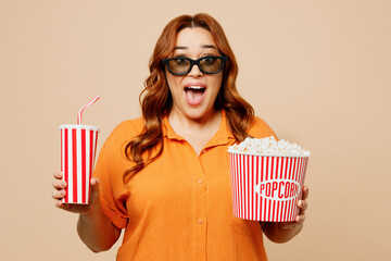 Young fun chubby overweight woman in 3d glasses wear orange shirt casual clothes watch movie film...