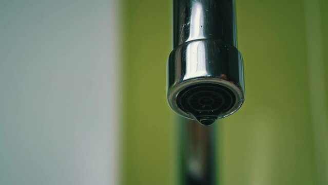 Close-up of water flowing from a kitchen faucet. drinking water from the tap. Tap water flows from the tap. Use of water resources. Mixer in the kitchen close-up.