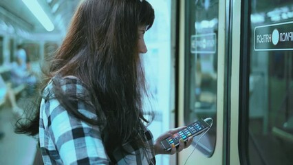 Metro Melodies: Woman Grooving to Music While Using Phone