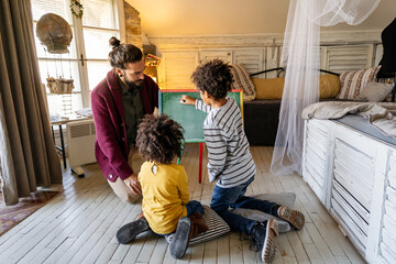 Happy children learning maths with foster father teacher at home. Family education happiness concept