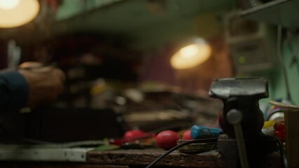 Senior technician electronics engineer repairs an old hi-fi receiver using a soldering iron in the small workshop close-up - Powered by Adobe