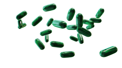 Green medical capsules falling down on the white background