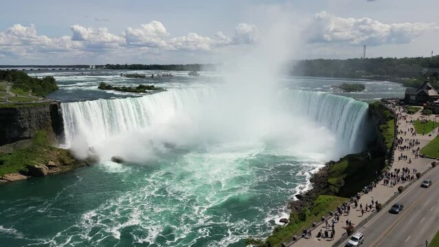 Aerial view Niagara Falls. Nature landscape with a river whose water falls from the rocks to the bottom. Incredible natural wonders in tourist spots. High quality 4k footage