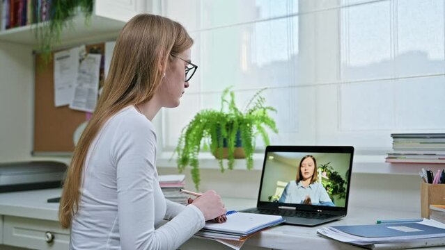 Teenager girl having online video conference therapy with psychologist