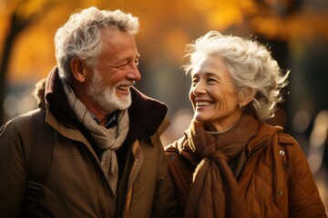 In love and happy senior couple walking in a autumn park and enjoying together