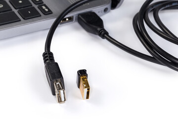 USB extension cable connected to laptop and USB device beside